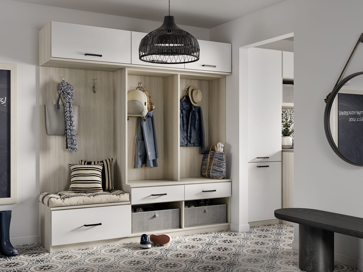 Mudroom and entryway design with storage cabinets and bench in white finish by California Closets
